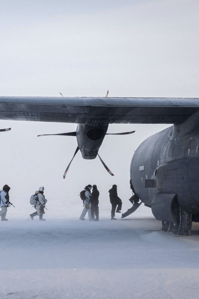 Soldiers entering a Military plane
